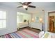 Cozy bedroom with colorful striped rug, white furniture, and connecting room view at 965 Tiverton Ln, Alpharetta, GA 30022