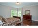 Comfortable bedroom with hardwood floors, large windows, and stylish furnishings for a relaxing retreat at 965 Tiverton Ln, Alpharetta, GA 30022