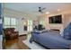 Comfortable bedroom with hardwood floors, plantation shutters, and a cozy reading nook at 965 Tiverton Ln, Alpharetta, GA 30022