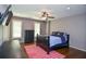 Comfortable bedroom with a bed, dark wood furniture, and plantation shutters at 965 Tiverton Ln, Alpharetta, GA 30022