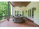 Spacious covered deck with dining area, offering a seamless transition to the outdoors and serene views at 965 Tiverton Ln, Alpharetta, GA 30022