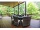 Inviting covered deck with outdoor dining set perfect for entertaining and enjoying nature at 965 Tiverton Ln, Alpharetta, GA 30022