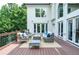 Relaxing outdoor deck featuring stylish patio furniture and beautiful views of the surrounding greenery at 965 Tiverton Ln, Alpharetta, GA 30022