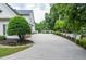 A long driveway leading to the house with manicured landscaping and green trees at 965 Tiverton Ln, Alpharetta, GA 30022