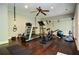 Well-equipped exercise room with modern equipment and hardwood flooring for a complete workout experience at 965 Tiverton Ln, Alpharetta, GA 30022