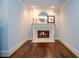 Cozy fireplace room with dark wood floors, traditional fireplace, soft, natural light, and light blue wall color at 965 Tiverton Ln, Alpharetta, GA 30022