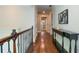 Well-lit hallway with hardwood floors and decorative accents at 965 Tiverton Ln, Alpharetta, GA 30022