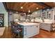 Kitchen island seating under a wood plank ceiling complements the stainless appliances and light-colored cabinets at 965 Tiverton Ln, Alpharetta, GA 30022