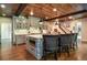Kitchen island seating under a wood plank ceiling complements the stainless appliances and light-colored cabinets at 965 Tiverton Ln, Alpharetta, GA 30022