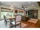 Open-concept living room featuring hardwood floors, built-in shelving, and natural light from large windows at 965 Tiverton Ln, Alpharetta, GA 30022