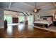 Spacious main bedroom with tray ceiling, dark wood floors, ceiling fan, and large windows with natural light at 965 Tiverton Ln, Alpharetta, GA 30022