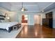 Open view of the main bedroom shows the wood floors, the ensuite bathroom, and a large dresser at 965 Tiverton Ln, Alpharetta, GA 30022
