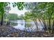 A serene lake view showcasing lush trees and a still body of water, creating a tranquil natural setting at 965 Tiverton Ln, Alpharetta, GA 30022