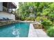Beautiful backyard pool area with stone patio, perfect for outdoor relaxation and entertaining with lush greenery at 965 Tiverton Ln, Alpharetta, GA 30022