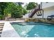 Sparkling backyard pool with waterfall feature, surrounded by stone accents and inviting patio seating at 965 Tiverton Ln, Alpharetta, GA 30022