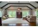 Bright sitting room with beamed, vaulted ceiling, dark wood floors, neutral colors, and large windows at 965 Tiverton Ln, Alpharetta, GA 30022