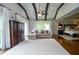Bright sitting room with beamed, vaulted ceiling, dark wood floors, neutral colors, large windows, and seating at 965 Tiverton Ln, Alpharetta, GA 30022