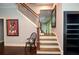 Elegant staircase with wood railings and a decorative black iron design leading to the upper level at 965 Tiverton Ln, Alpharetta, GA 30022