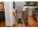 View of wooden staircase leading to basement, with hardwood floors and decorative railing at 965 Tiverton Ln, Alpharetta, GA 30022