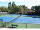 Exterior image showcasing the tennis courts, surrounded by mature trees at 965 Tiverton Ln, Alpharetta, GA 30022