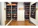 Custom walk-in closet with built-in shoe racks and mirrored door at 965 Tiverton Ln, Alpharetta, GA 30022