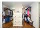 Spacious walk-in closet with custom wood shelving and dresser at 965 Tiverton Ln, Alpharetta, GA 30022
