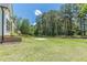Expansive backyard featuring lush greenery and a new construction home with a covered patio at 4075 O Henry Ct, Mcdonough, GA 30252