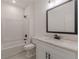 Bright bathroom featuring a shower-tub combo, vanity with marble countertop, and black fixtures at 4075 O Henry Ct, Mcdonough, GA 30252