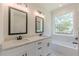 This primary bathroom features double sinks, marble countertops, a soaking tub, and modern fixtures at 4075 O Henry Ct, Mcdonough, GA 30252