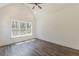 Bedroom with dark floors and a high ceiling has a large window looking out onto the green space at 4075 O Henry Ct, Mcdonough, GA 30252