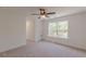 Bright bedroom with a large window, light-colored carpet, white trim and doors, and a ceiling fan at 4075 O Henry Ct, Mcdonough, GA 30252