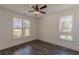 Sunlit bedroom with two windows offering neighborhood views and stylish ceiling fan at 4075 O Henry Ct, Mcdonough, GA 30252