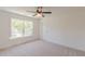Bright bedroom with a large window, light-colored carpet, white trim and doors, and a ceiling fan at 4075 O Henry Ct, Mcdonough, GA 30252