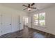 Bright bedroom with ceiling fan, showcasing window views and an entryway to the foyer at 4075 O Henry Ct, Mcdonough, GA 30252