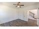 Spacious bedroom featuring a ceiling fan, two doors and a view of the staircase at 4075 O Henry Ct, Mcdonough, GA 30252