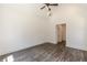 Bedroom with dark floors and a high ceiling has a ceiling fan and entry to another room at 4075 O Henry Ct, Mcdonough, GA 30252
