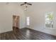 A bright bedroom with dark wood-look flooring, high ceilings, a ceiling fan, and white trim at 4075 O Henry Ct, Mcdonough, GA 30252