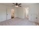 Spacious carpeted bedroom with white trim, doors, and ceiling fan at 4075 O Henry Ct, Mcdonough, GA 30252