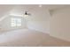 Neutral carpeted bonus room featuring windows and a ceiling fan at 4075 O Henry Ct, Mcdonough, GA 30252