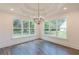 Open dining room with wood floors, lots of natural light, and wooded views at 4075 O Henry Ct, Mcdonough, GA 30252