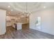 Open dining room and kitchen featuring wood floors and modern light fixtures at 4075 O Henry Ct, Mcdonough, GA 30252