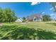 Wide view of the rear exterior with a patio, siding and roof, and a sprawling green yard at 4075 O Henry Ct, Mcdonough, GA 30252