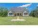 Well manicured lawn leading to a charming exterior of the home, with a covered back porch at 4075 O Henry Ct, Mcdonough, GA 30252