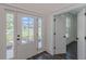 Entryway featuring a glass front door and sidelights, allowing ample natural light into the home at 4075 O Henry Ct, Mcdonough, GA 30252