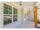 Inviting front porch with brick columns, a white front door, and manicured landscaping at 4075 O Henry Ct, Mcdonough, GA 30252