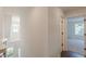 This second-floor hallway gives a peek into another room with a window and a ceiling fan at 4075 O Henry Ct, Mcdonough, GA 30252