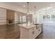 Open kitchen featuring a center island with a farmhouse sink, white cabinets, and pendant lighting at 4075 O Henry Ct, Mcdonough, GA 30252