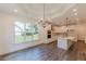 Modern kitchen with white cabinets, island, stainless steel appliances, and wood floors at 4075 O Henry Ct, Mcdonough, GA 30252