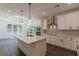 Modern kitchen with white cabinets, stainless steel appliances, and a large center island at 4075 O Henry Ct, Mcdonough, GA 30252