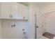 Laundry room with white cabinets, utility sink hookups, and tile floor at 4075 O Henry Ct, Mcdonough, GA 30252
